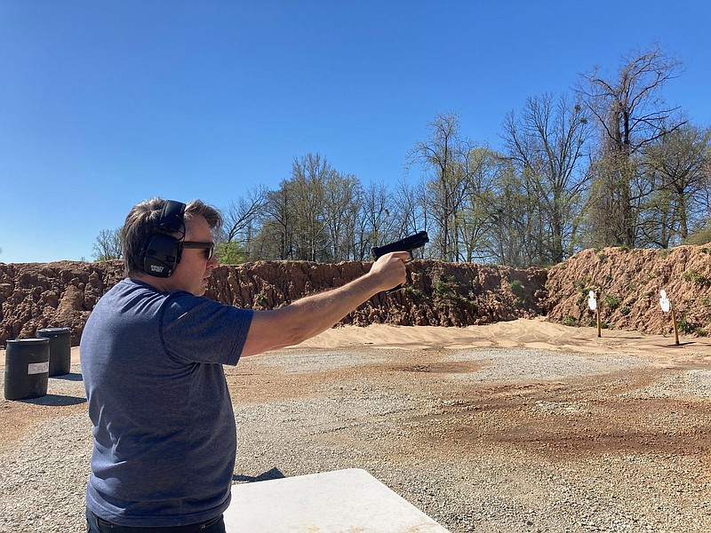 Tre Kitchens of Little Rock fires a handgun April 9 at Twisted Barrel Precision near Sweet Home.
(Arkansas Democrat-Gazette/Bryan Hendricks)