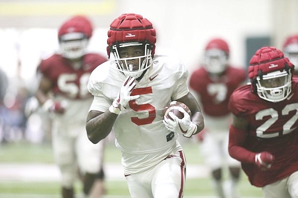 Arkansas running back Raheim Sanders (5) carries the ball during a scrimmage Saturday, April 16, 2022, in Fayetteville.