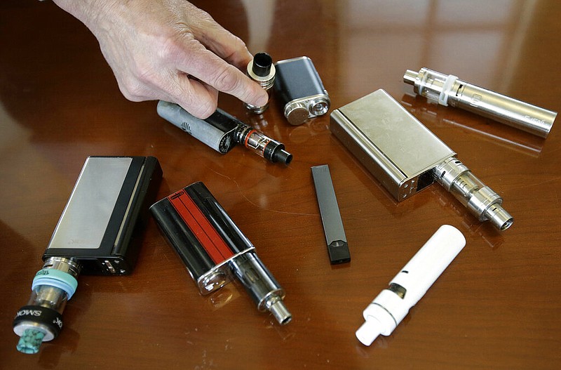 Robert Keuther, principal of Marshfield (Mass.) High Schoo, displays vaping devices that were confiscated from students in such places as restrooms or hallways at the school in this April 10, 2018 file photo. (AP/Steven Senne)