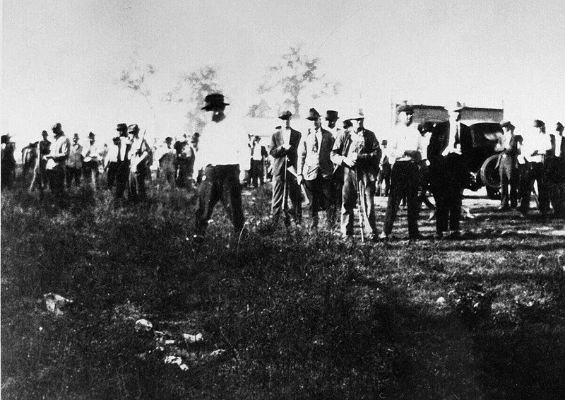 Unidentified white posse members hunt for black men who had taken refuge in a field in Elaine in this photo taken in late September or early October 1919. The events in Elaine had for years been referred to as a race riot in which black sharecroppers and white farmers battled and then-Gov. Charles Brough declared martial law, but it is now more commonly called a massacre in which 100 people, and perhaps as many as 800, were killed. (AP/Governor Charles Brough Scrapbook, Arkansas History Commission, File)