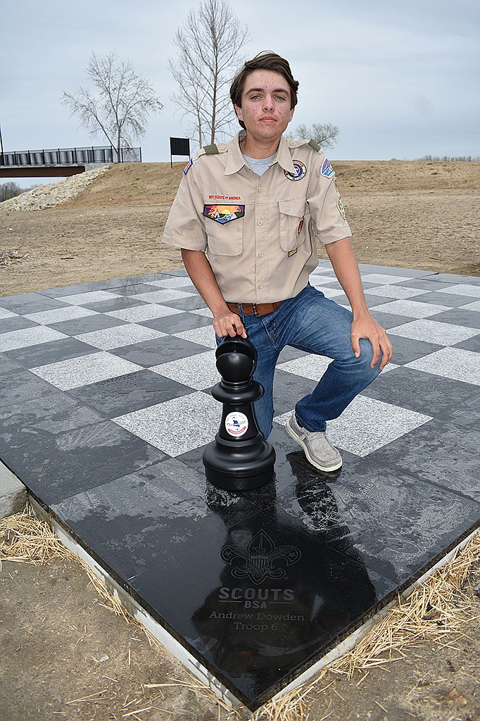 Andrew Dowden poses with the chess board he created and installed on Adrian’s Island as part of his Eagle project. Dowden, a junior at Helias Catholic High School, is a Scout at Immaculate Conception School’s Troop 6. (Gerry Tritz/News Tribune)
