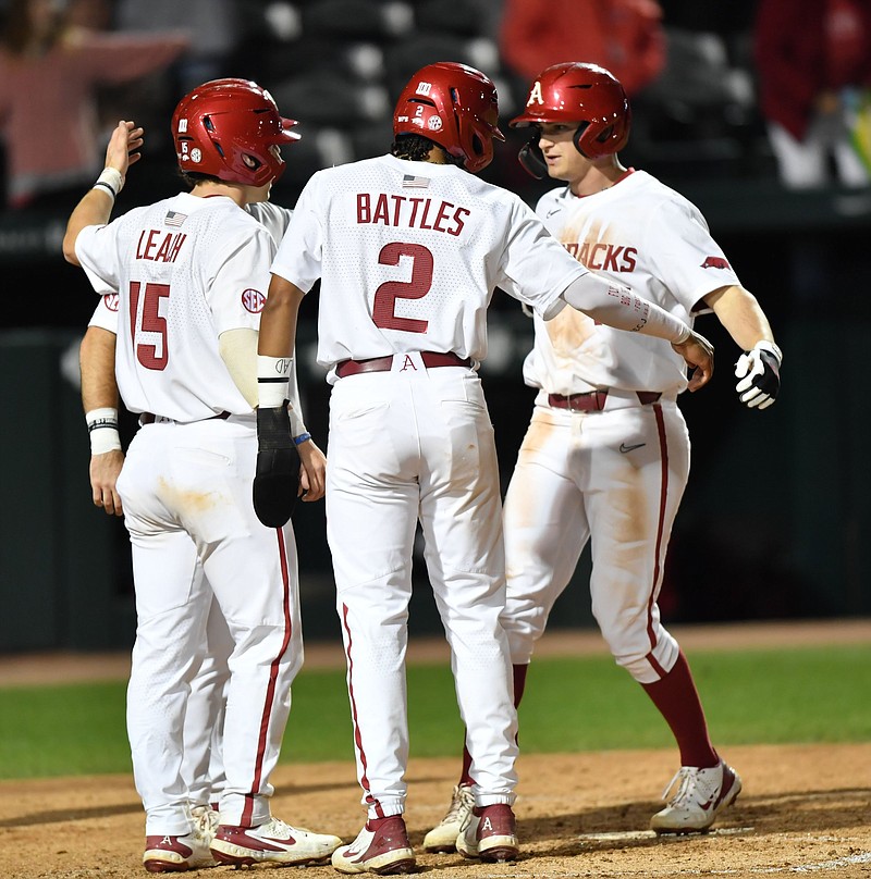 Arkansas right fielder Brady Slavens (right) is congratulated Tuesday, April 19, 2022, by catcher Dylan Leach (15) shortstop Jalen Battles (2) and first baseman Peyton Stovall after hitting a grand slam during the seventh inning against Arkansas State at Baum-Walker Stadium in Fayetteville. Visit nwaonline.com/220420Daily/ for today's photo gallery. .(NWA Democrat-Gazette/Andy Shupe)