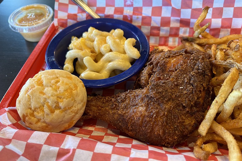 We got our dark meat fried chicken quarter with mac 'n' cheese, fries, a honey-mustard dipping sauce and a cheddar “biscuit” at Waldo’s Chicken & Beer, 4221 Warden Road, North Little Rock. (Arkansas Democrat-Gazette/Eric E. Harrison)