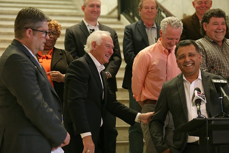 North Little Rock Mayor Terry C. Hartwick, center, shares a laugh with developer James Thomas, far right, during a press conference at city hall announcing a new multi-million dollar entertainment development Friday, April 22, 2022. (Arkansas Democrat-Gazette/Colin Murphey)