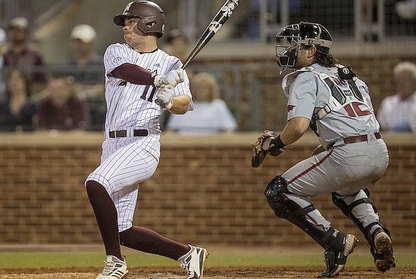 Texas A&M's Austin Bost, left, singles against Arkansas during an NCAA college baseball game Friday, April 22, 2022, in College Station, Texas. (Michael Miller/College Station Eagle via AP)