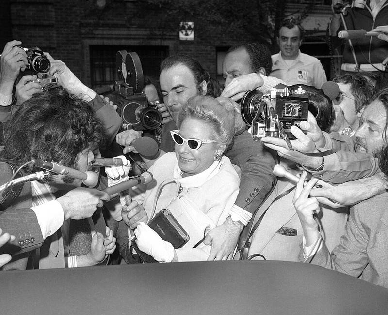 Pine Bluff native Martha Beall Mitchell carries a worn Bible as she makes her way through throngs of newsmen to give a deposition about the Watergate case to a lawyer in New York City in this May 3, 1973 file photo. Mitchell was the wife of John Mitchell, who served as attorney general under President Richard M. Nixon. When Martha Mitchell was asked why she was carrying a Bible to the deposition, she quipped, “I wouldn’t want to have to swear on a dictionary.” (AP Photo)