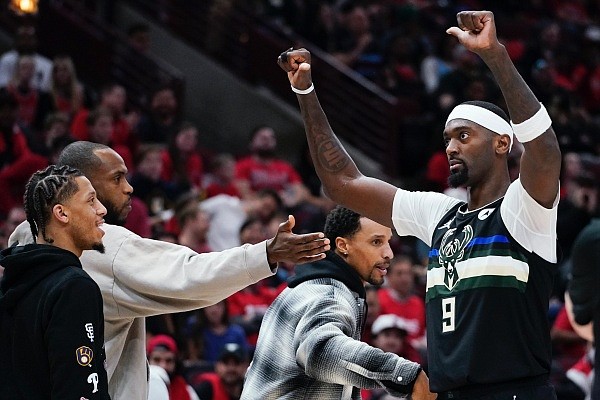 Milwaukee Bucks center Bobby Portis, right, celebrates with teammates as he walks back to the bench during the second half of Game 4 of a first-round NBA basketball playoff series against the Chicago Bulls Sunday, April 24, 2022, in Chicago. The Bucks won 119-95. (AP Photo/Nam Y. Huh)