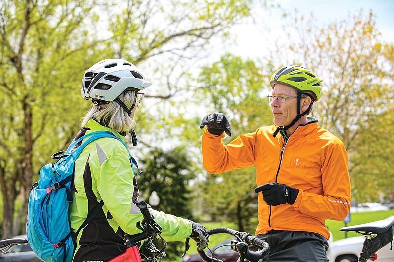 City Engineer and avid bicyclist David Bange, right, talks cycling with fellow enthusiast Celeste Koon on Monday, April 25, 2022, before the start of the Legislators Bicycle Ride to the Katy Trail. The annual event is designed to increase support for bicycling. Koon is active in Jefferson City helping to create mountain biking trails. (Juile Smith/News Tribune photo)