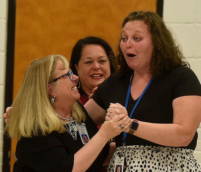 Kamisha Burlingame (right) is congratulated Wednesday after receiving the Milken Educator Award at Thomas Jefferson Elementary in Bentonville.
(NWA Democrat-Gazette/Flip Putthoff)