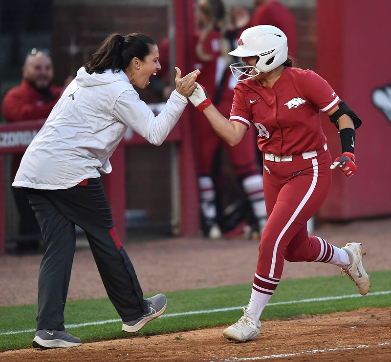 Arkansas shortstop Marlene Friedman (right) celebrates Tuesday, April 26, 2022, with coach Courtney Deifel after hitting a go-ahead, two-run home run during the sixth inning of the Razorbacks? 3-2 win over Central Arkansas at Bogle Park in Fayetteville. Visit nwaonline.com/220427Daily/ for today's photo gallery. .(NWA Democrat-Gazette/Andy Shupe)