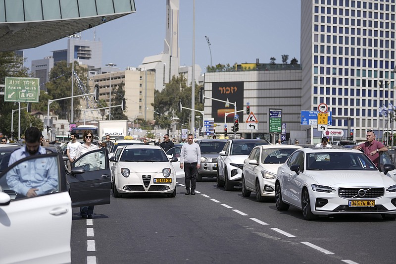 Israelis stand next to their cars on a main road as a two-minute siren sounds Thursday in memory of victims of the Holocaust in Tel Aviv, Israel.
(AP/Ariel Schalit)