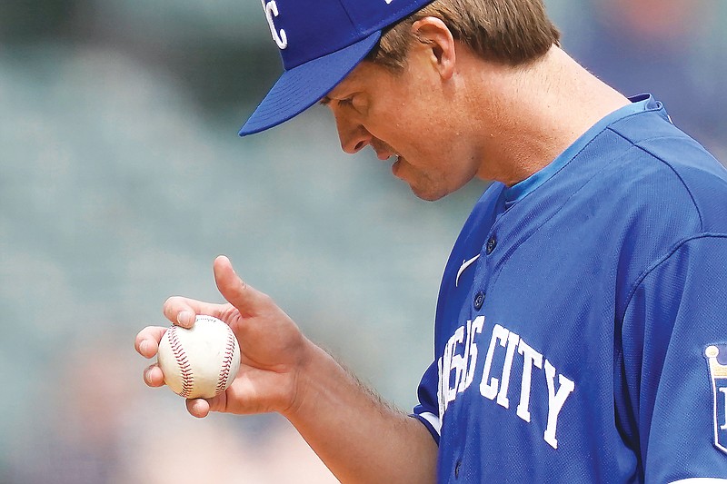 Royals starting pitcher Zack Greinke looks at a baseball during Wednesday's game against the White Sox in Chicago. (Associated Press)