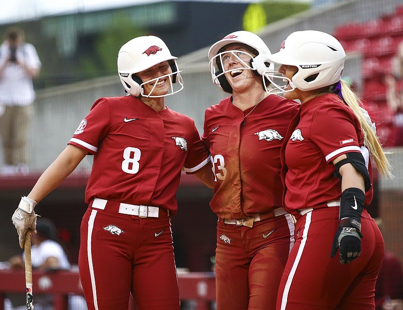 Arkansas senior Hannah McEwen (center) celebrates with teammates after hitting an inside-the-park home run during Friday night’s victory over South Carolina at Bogle Park in Fayetteville.
(Special to the NWA Democrat-Gazette/David Beach)
