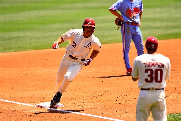 Arkansas' Chris Lanzilli (18) rounds third base after hitting a home run during a game against Ole Miss on Sunday, May 1, 2022, in Fayetteville.