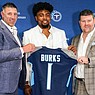 Tennessee Titans first-round NFL football draft pick wide receiver Treylon Burks, center, holds up his jersey with head coach Mike Wrabel, left, and general manager Jon Robinson, right, during an introductory news conference at Saint Thomas Sports Park in Nashville, Friday, April 29, 2022. (Andrew Nelles/The Tennessean via AP)