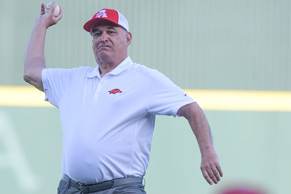 Retired Hawgs Illustrated publisher Clay Henry throws a ceremonial first pitch prior to a game between Arkansas and Ole Miss on Saturday, April 30, 2022, in Fayetteville. Retired Hawgs Illustrated publisher Clay Henry throws a ceremonial first pitch prior to a game between Arkansas and Ole Miss on Saturday, April 30, 2022, in Fayetteville.