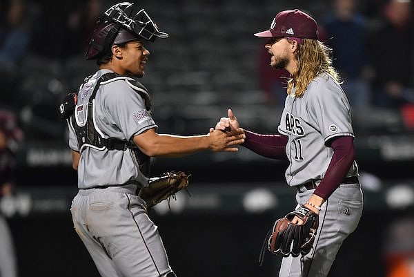 Missouri State catcher Drake Baldwin (left) and relief pitcher Jake McMahill celebrate Tuesday, May 3, 2022, after the Bears' 6-4 win over Arkansas at Baum-Walker Stadium in Fayetteville.