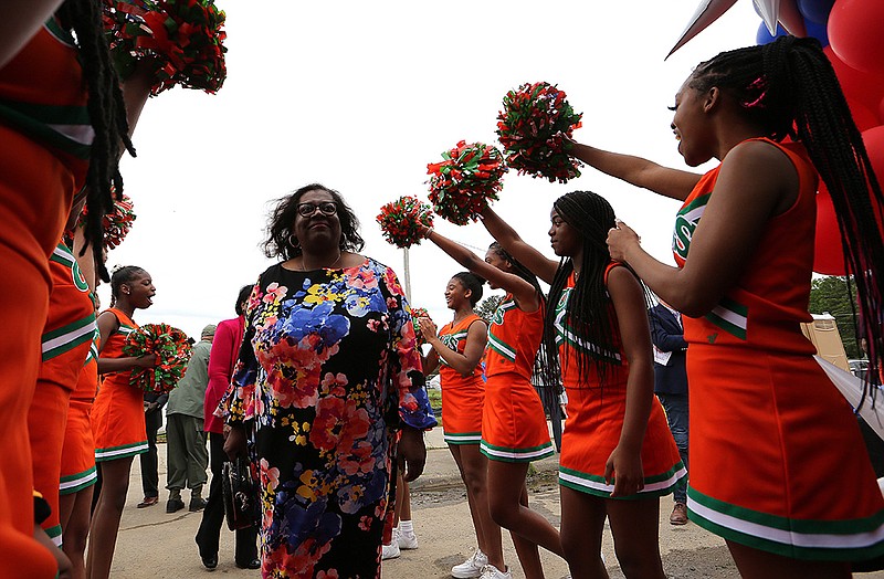 Cloverdale Middle School cheerleaders greet Cynthia Lacey, daughter of Marian Lacey, at the groundbreaking Wednesday for the Dr. Marian G. Lacey K-8 Academy on the site of the old John L. McClellan High School in Southwest Little Rock. Her father, Jesse Lacey, a former Little Rock School District administrator, spoke at the event. More photos at arkansasonline.com/55lacey/.
(Arkansas Democrat-Gazette/Thomas Metthe)