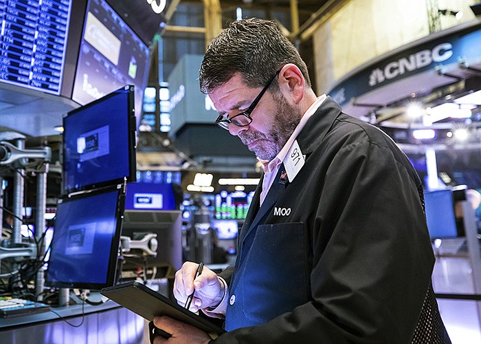 A trader works Thursday on the floor at the New York Stock Exchange as share prices post losses. “There’s still a lot of fear out there,” Dennis Dick of Bright Trading said, citing persistent inflation.
(AP/New York Stock Exchange/David L. Nemec)