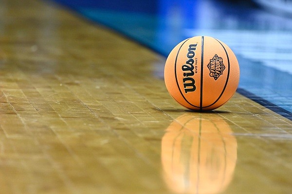 An NCAA basketball with the Final Four logo on it rests on the court during a first-round NCAA college basketball tournament game between Seton Hall and TCU, Friday, March 18, 2022, in San Diego. (AP Photo/Denis Poroy)