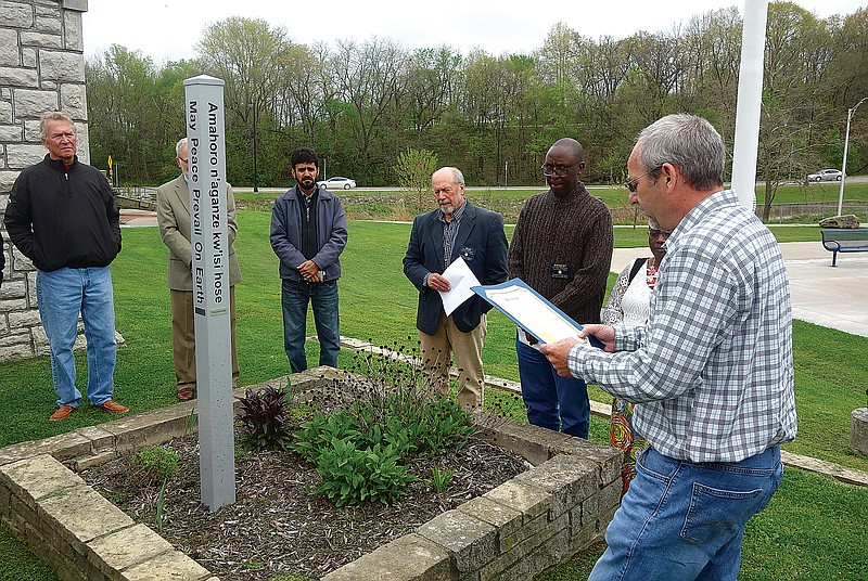 Fulton Mayor Lowe Cannell delivers a proclamation Wednesday during the dedication of Fulton Rotary's peace pole in Memorial Park. (Michael Shine/Fulton Sun)