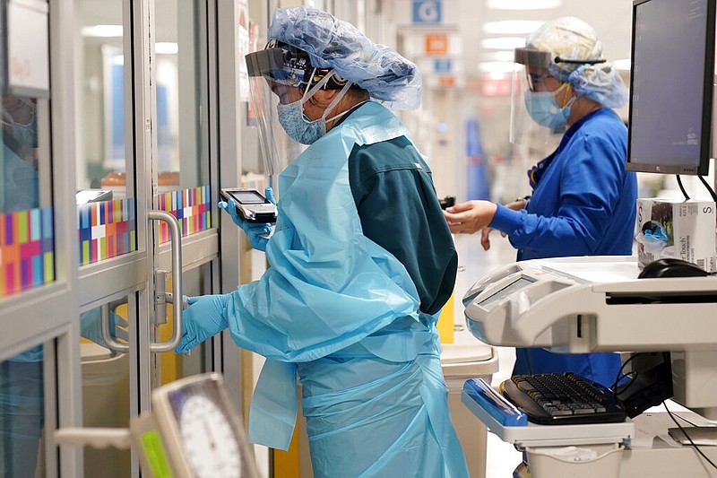 Medical personnel don personal protective equipment while attending to a patient who is not infected with covid-19 at Bellevue Hospital in New York in this Oct. 28, 2020 file photo. (AP/Seth Wenig)