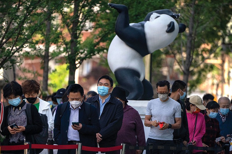 People stand in line for covid-19 testing Saturday in Beijing after authorities ordered a third round of three consecutive coronavirus tests for residents in the Chaoyang district of the city.
(AP/Mark Schiefelbein)