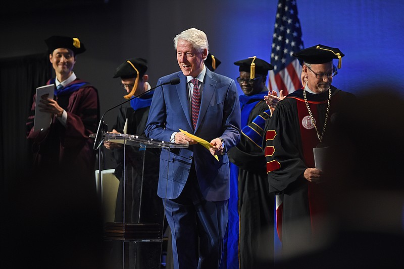 Former President Bill Clinton makes his way to the podium during the University of Arkansas Clinton School of Public Service Commencement Ceremony on Saturday at the Statehouse Convention Center in Little Rock. More photos at arkansasonline.com/58clinton/.
(Arkansas Democrat-Gazette/Staci Vandagriff)