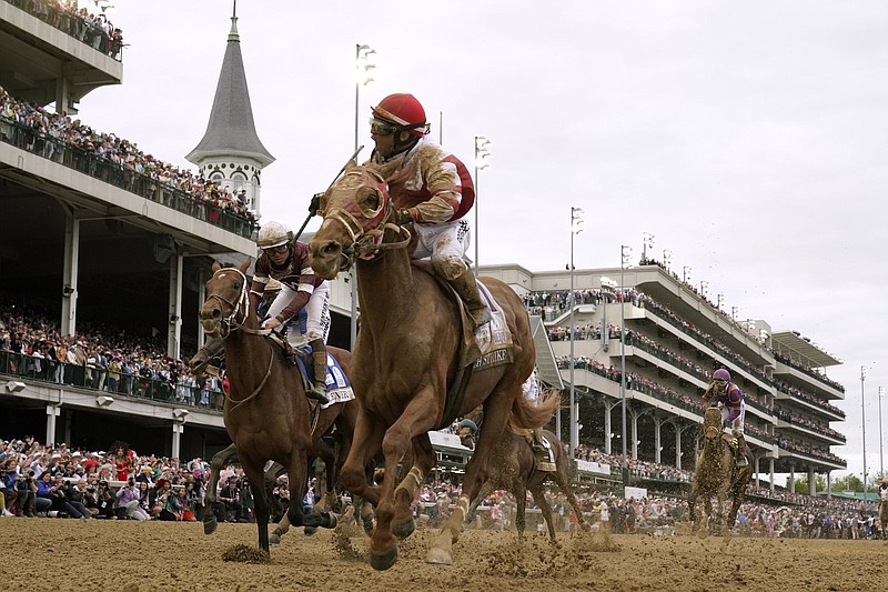 Jockey Sonny Leon guides Rich Strike (center) to victory in the 148th running of the Kentucky Derby, beating 4-1 favorite Epicenter (left), ridden by Joel Rosario, by three-quarters of a length in an 80-1 upset Saturday at Churchill Downs in Louisville, Ky.
(AP Photo/Jeff Roberson)