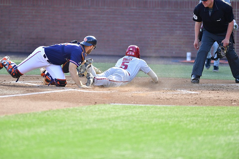 Designated hitter Kendall Diggs slides in for a score past catcher Nate LaRue in the top of the second inning to give Arkansas a short-lived 1-0 lead in a 5-3 loss to Auburn on Saturday at Auburn, Ala.
(Auburn Athletics/Jacob Taylor)