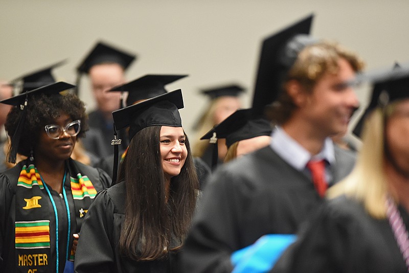 University of Arkansas Clinton School of Public Service graduates make their way to their seats at the beginning of the commencement ceremony Saturday, May 7, 2022 at the Statehouse Convention Center in Little Rock.(Arkansas Democrat-Gazette/Staci Vandagriff)