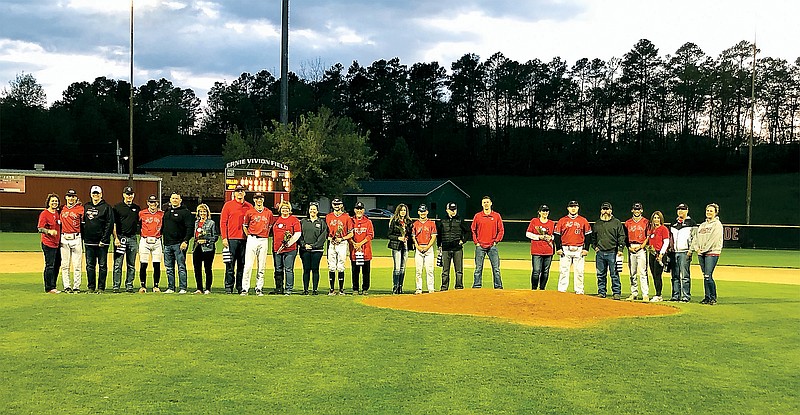 The seven Jefferson City Jays baseball seniors stand on the field with their parents Friday night at Vivion Field. (Trevor Hahn/News Tribune)