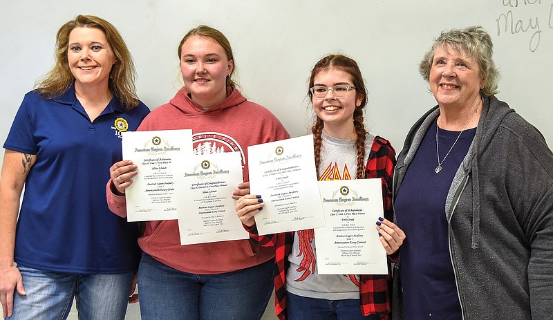 Representing American Legion Unit 5 Auxiliary, Paula Harmon, left,  and Charlotte Dudenhoeffer, far right, visited Russellville High School Friday, May 6, 2022, to present Jillian Schmidt, second from left, and Emily Jurgle certificates recognizing the quality of their recent essays in both local and district levels.(Julie Smith/News Tribune photo)