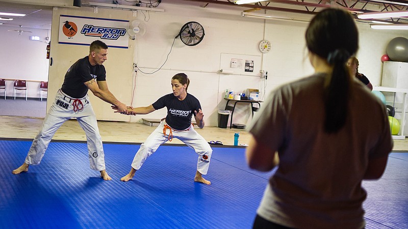 Jiu-jitsu instructors Clay and Janice Herron demonstrate how to get out of a two-handed wrist grab at HerronBJJ.