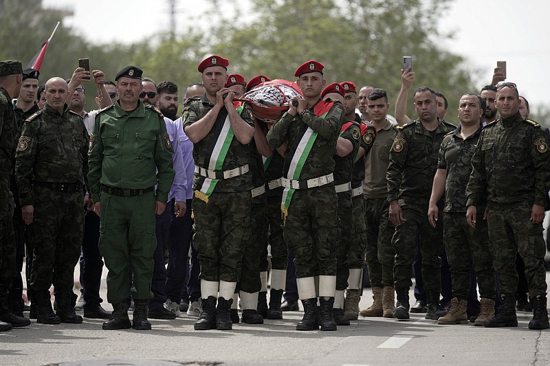 Slain Al Jazeera veteran journalist Shireen Abu Akleh is carried by a Palestinian honor guard Wednesday in the West Bank city of Nablus.
(AP/Majdi Mohammed)