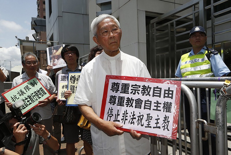 Hong Kong’s outspoken cardinal Joseph Zen (center) and other religious protesters hold placards with “Respects religious freedom” written on them during a demonstration on July 11, 2012, outside the China Liaison Office in Hong Kong.
(AP/Kin Cheung)