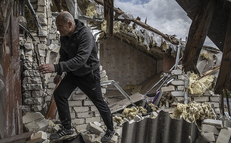 Yuri Emets walks through his damaged home in the village of Vilhivka, Ukraine, on Wednesday. Emets discovered the bodies of seven Ukrainian soldiers in his back yard after the town, located east of the city of Kharkiv, was reclaimed from Russian occupying forces in recent weeks.
(The New York Times/Finbarr O’Reilly)