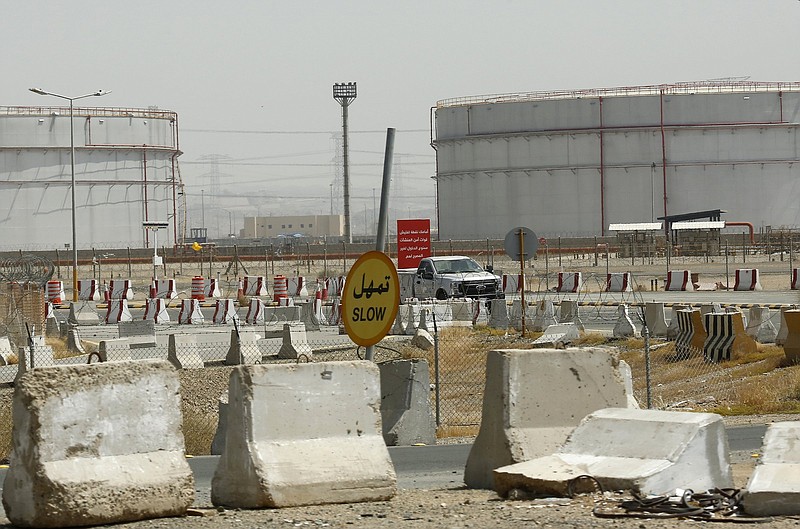 A vehicle passes in front of oil storage tanks at the North Jiddah bulk plant, an Aramco oil facility, in Jiddah, Saudi Arabia.
(AP)