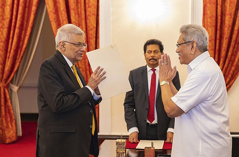 President Gotabaya Rajapaksa (right) greets Ranil Wickremesinghe during the latter’s oath taking ceremony as the new prime minister Thursday in Colombo, Sri Lanka.
(AP/Sri Lankan President’s Office)