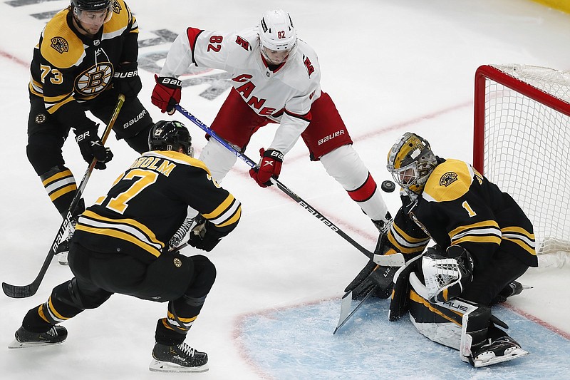 Boston goaltender Jeremy Swayman blocks a shot by Carolina’s Jesperi Kotkaniemi during the second period of the Bruins’ 5-2 loss to the Hurricanes in Game 6 of their NHL Eastern Conference first-round series in Boston on Thursday night.
(AP/Michael Dwyer)