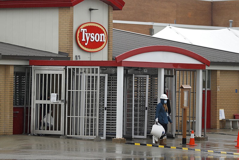 A Tyson Fresh Meats plant employee, wearing gear to protect against covid-19, leaves the plant in Logansport, Ind., in this April 23, 2020 file photo. (AP/Darron Cummings)
