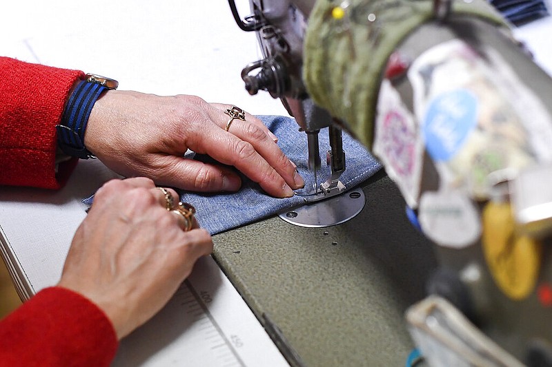 A woman works at her sewing machine in this June 18, 2020 file photo. (AP/Alberto Pezzali)