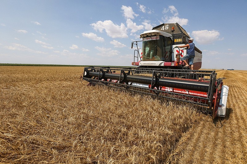 A combine harvester drives through a wheat field during the summer harvest in July 2021 on a farm in Tersky village, near Stavropol, Russia.
(Bloomberg/Andrey Rudakov)