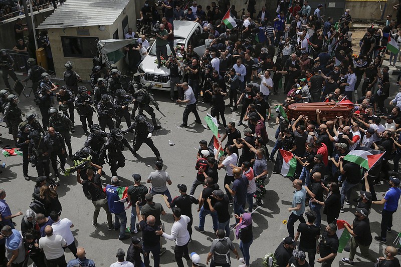 Israeli police confront mourners as they carry the casket of slain Al Jazeera veteran journalist Shireen Abu Akleh during her funeral Friday in east Jerusalem.
(AP/Maya Levin)