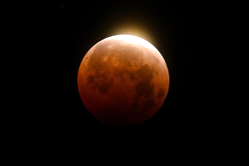 Light shines from a total lunar eclipse over Santa Monica Beach in Santa Monica, Calif., in this May 26, 2021 file photo. (AP/Ringo H.W. Chiu)