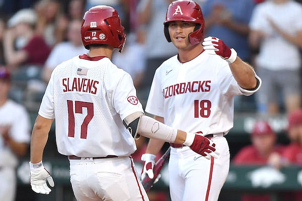 Arkansas first baseman Brady Slavens (17) is congratulated by right fielder Chris Lanzilli Friday, May 13, 2022, after hitting a solo home run during the fourth inning of play against Vanderbilt at Baum-Walker Stadium in Fayetteville.