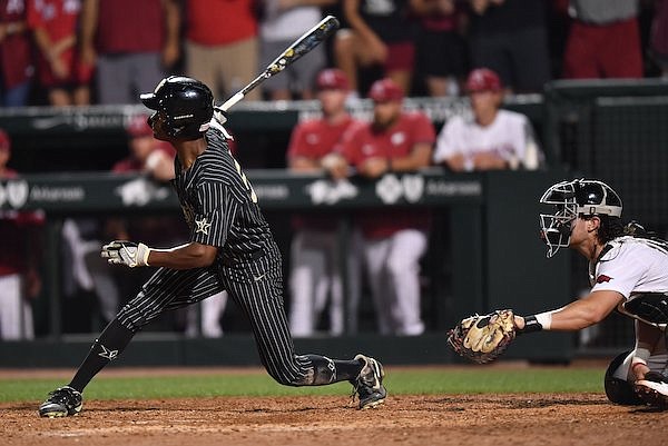 Vanderbilt center fielder Enrique Bradfield connects Friday, May 13, 2022, for a tie-breaking, three-run home run during the 10th inning of play against Arkansas at Baum-Walker Stadium in Fayetteville.