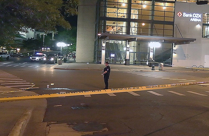 Crime scene tape surrounds the scene at the intersection of Convention Boulevard and Laurel Street, outside the Hot Springs Convention Center, Thursday night in the aftermath of a shooting in which four people were injured by gunfire, with one victim later dying.
(The Sentinel-Record/Andrew Mobley)