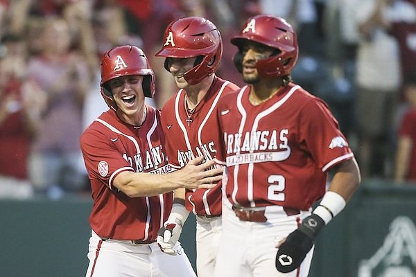 Arkansas' Cayden Wallace (7), Jace Bohrofen (8) and Jalen Battles (2) celebrate following Wallace's three-run home run in the fourth inning of a game against Vanderbilt on Saturday, May 14, 2022, in Fayetteville.
