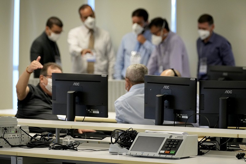 Analysts test the electronic voting system at the headquarters of the Supreme Electoral Court Friday in Brasilia, Brazil.
(AP/Eraldo Peres)